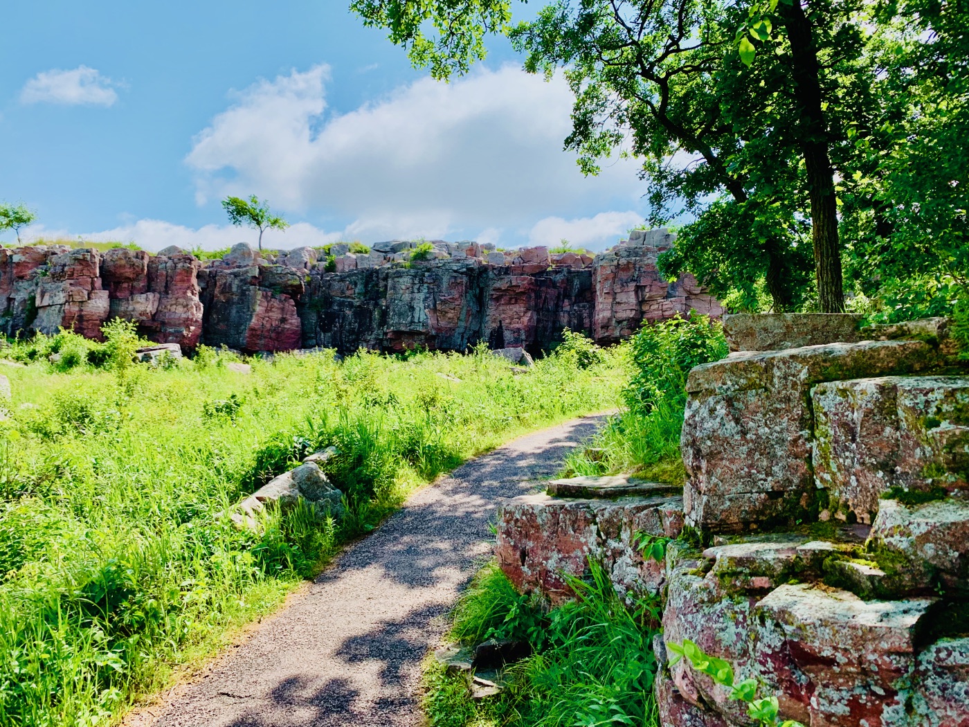 The trail through Pipestone, the pink Sioux quartzite ledge rising out of restored tallgrass prairie