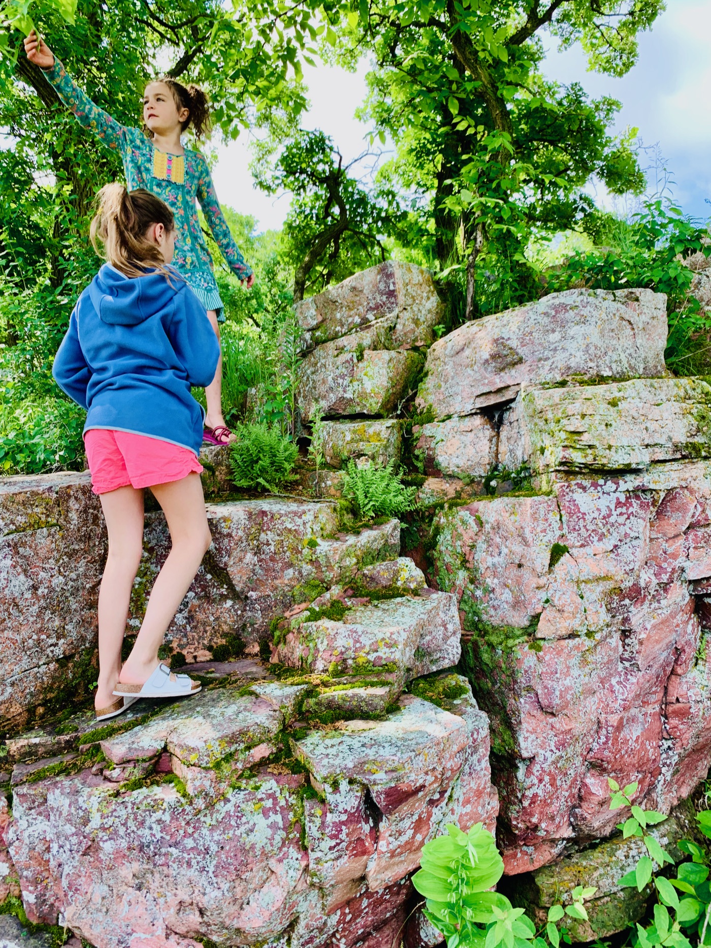 Climbing the stepped red rock along the trail
