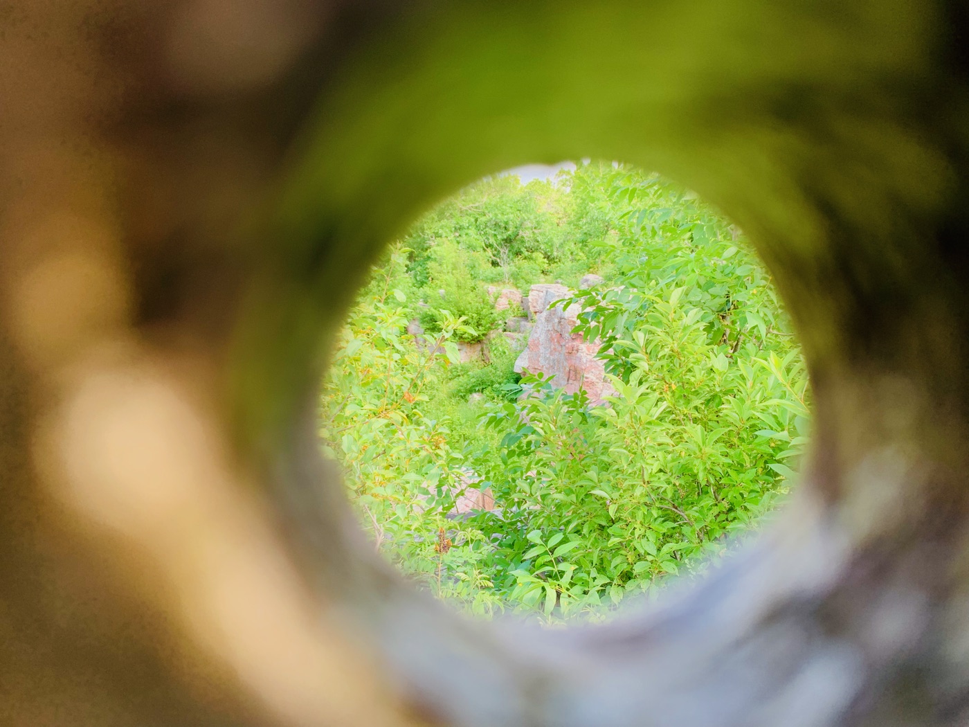 Peering through the Oracle's opening at the sacred red rock beyond
