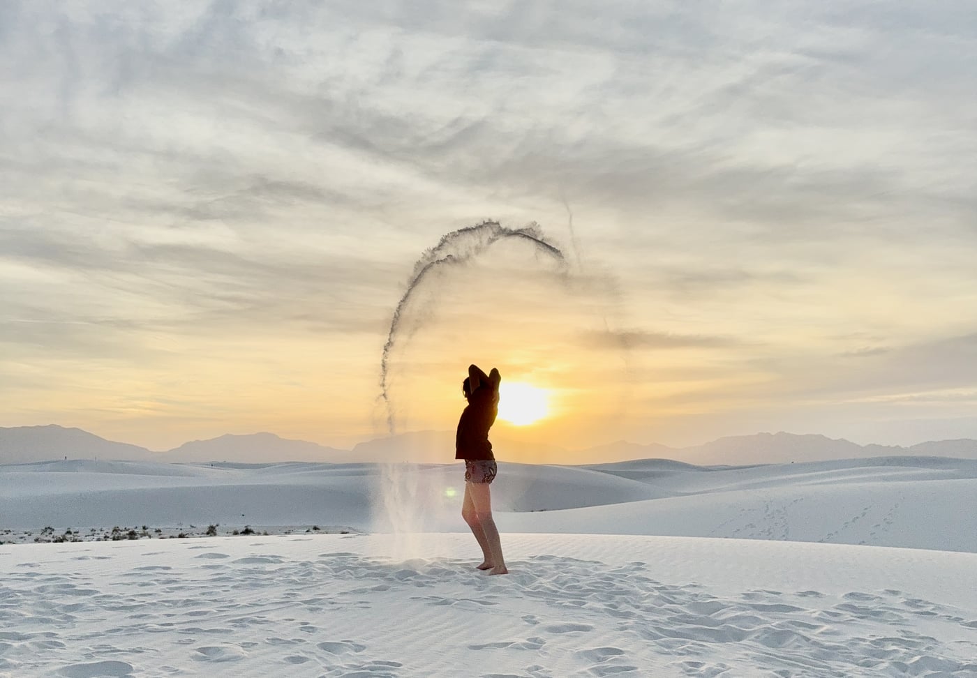 Phalen throwing sand at sunset, magic circle with the San Andres Mountains in the background