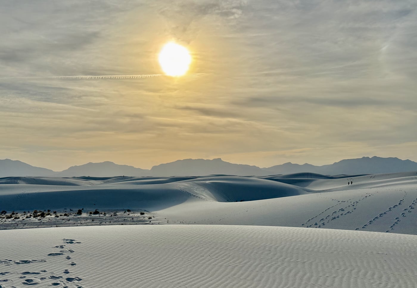White Sands yellow sun and the San Andres Mountains outlined against the sky