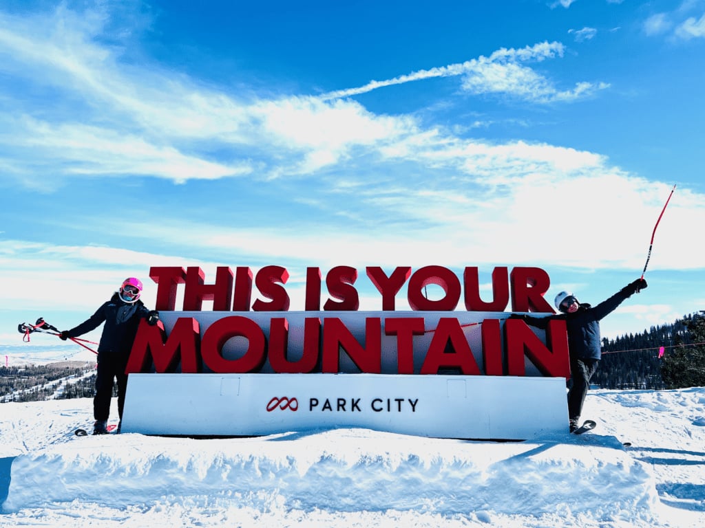 Park City Ski This is Your Mountain sign with happy ski kids and blue skies in the background