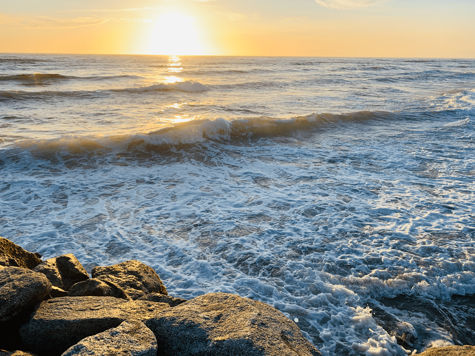 Waves and yellow sunset at Moss Landing State Beach