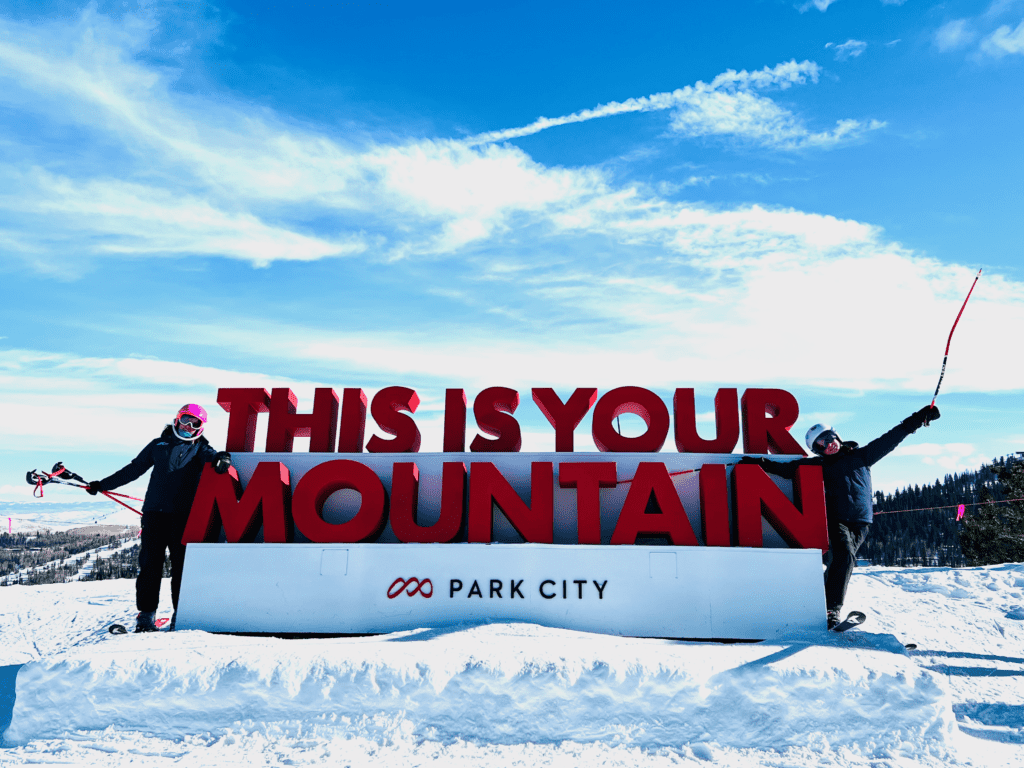 Park City Ski This is Your Mountain sign with happy ski kids and blue skies in the background